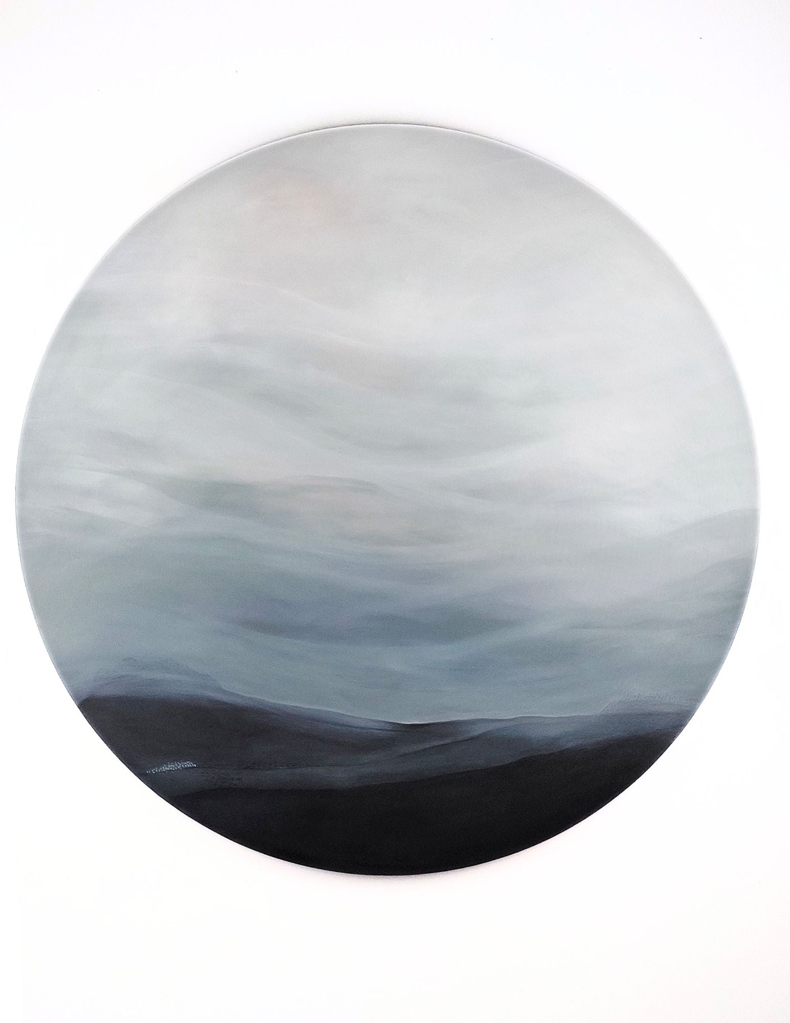 Beyond the Horizon by Leanne Aroha Mulder – large round painting with soft hills and a misty sky in subdued tones, evoking quiet reflection and calm.